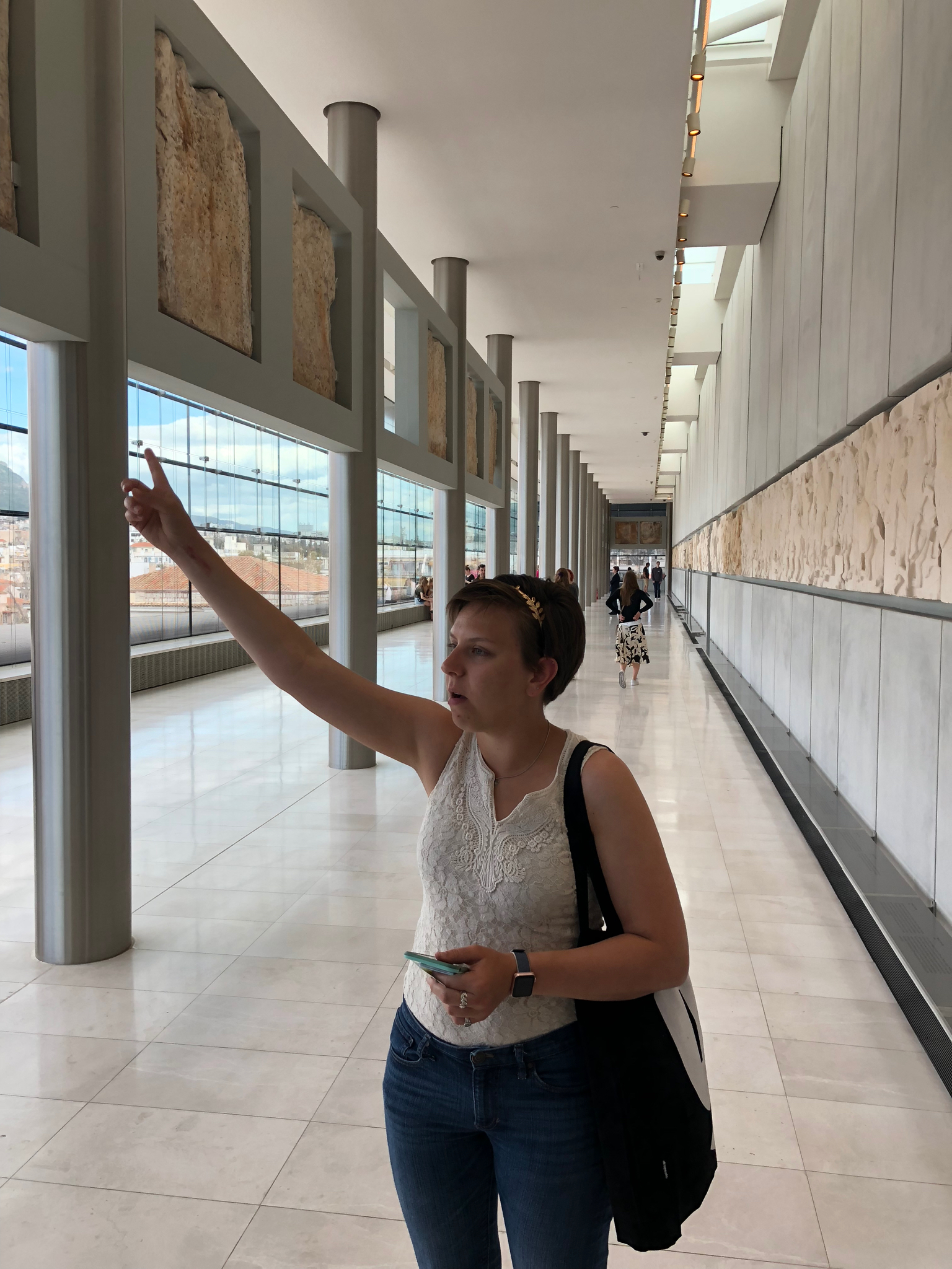 Isabel geeking out giving us a tour of the highlights of the museum. This top floor is oriented the same as the Parthenon, and is the same dimensions (the steel columns indicate the positions of the outer columns of the temple). It houses the panels of the frieze and “metopes” that originally were mounted high up all around the temple. In a very sad display of current politics, only a small number are originals. The rest are casts of the originals which were looted during ottoman rule (mostly by the British) and never returned. There is a spot in the display for every panel, with the original when available, a cast when the original is elsewhere, and an empty space where the original is lost or not yet found.