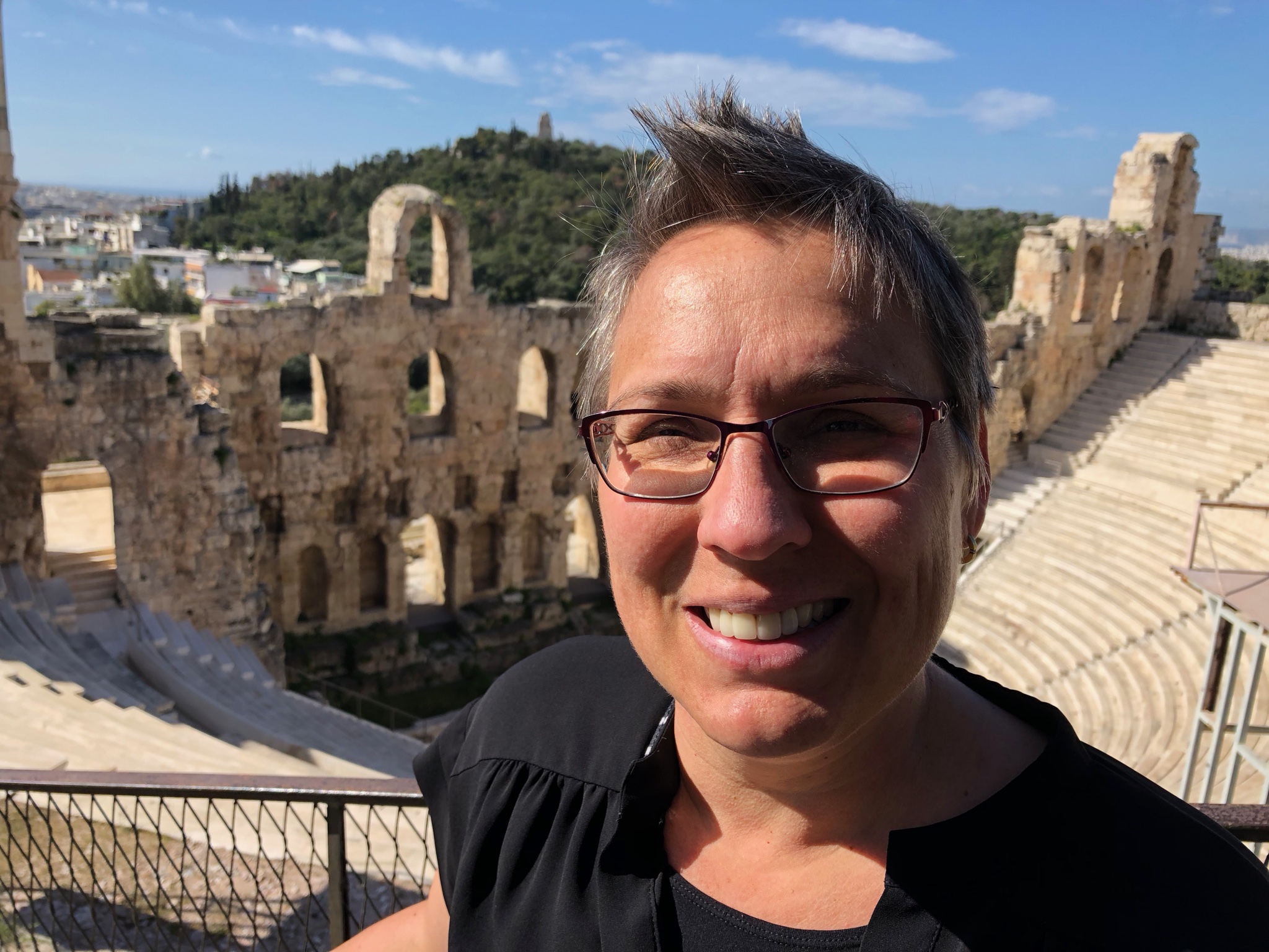 Mamie with the Roman-built Odeon behind. The Odeon itself (not the wall you see behind but the seats and stage) was reconstructed in the 1950s and it’s used for performances today.