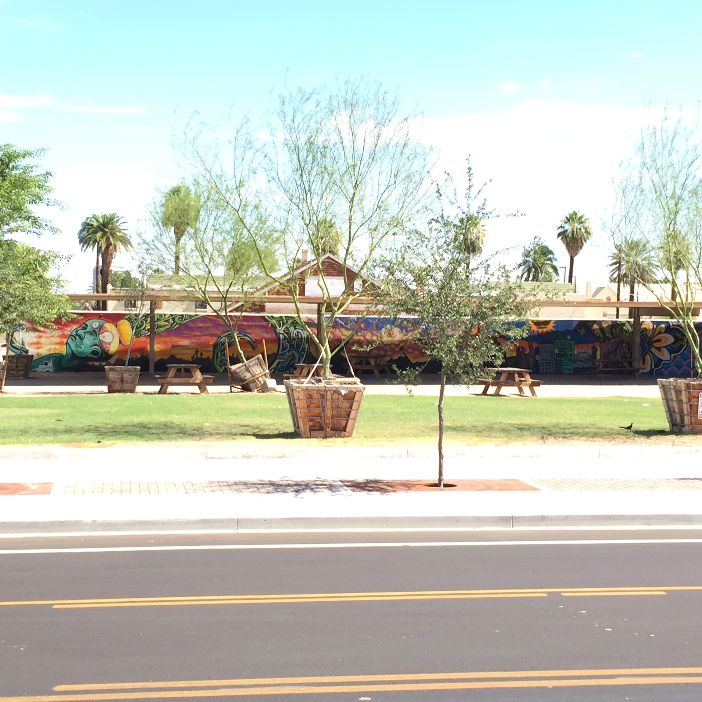 A long wall of mixed imagery in the Arts district.