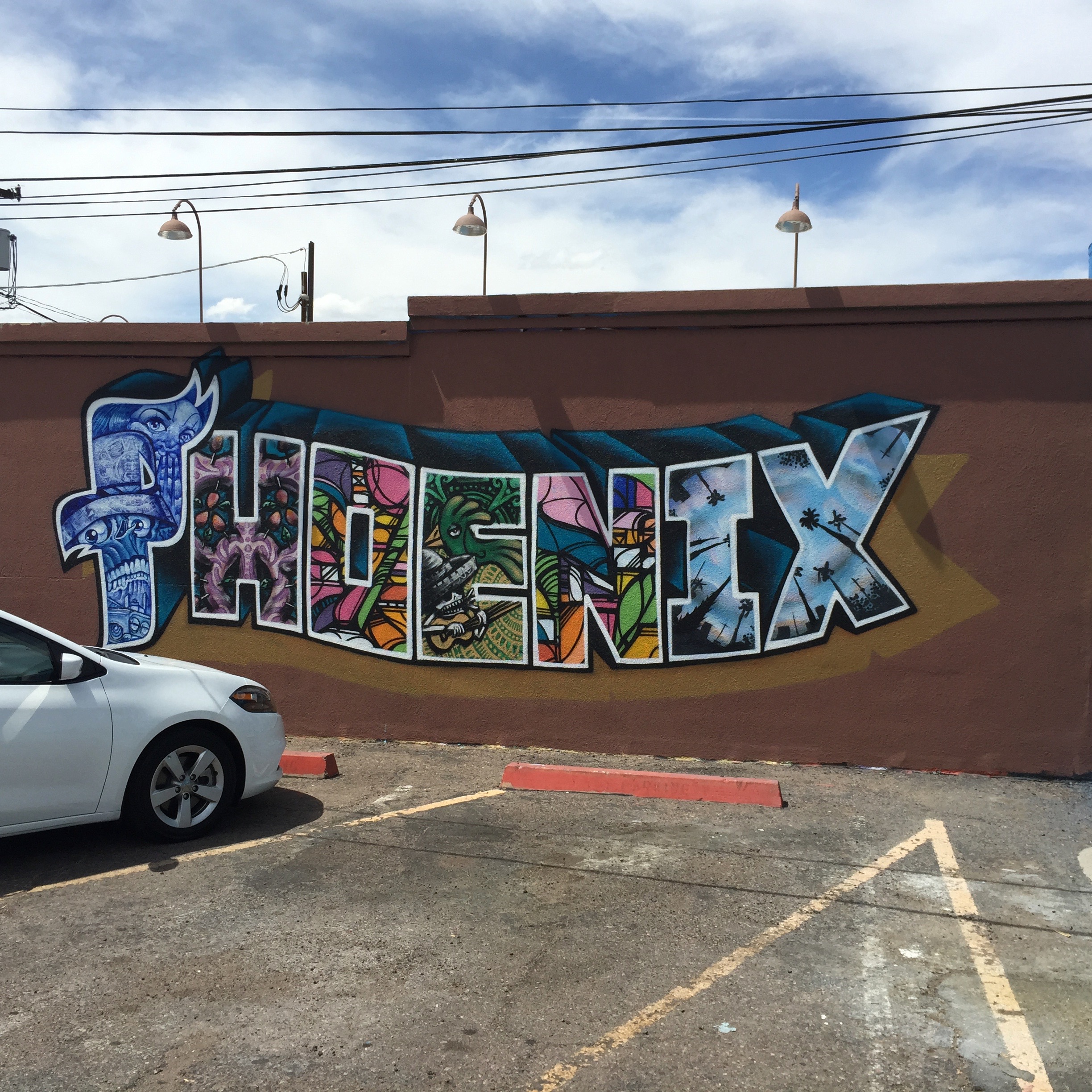 The stuff of airport postcards, but stunning none the less. I believe this was a collaborative work with different local artists filling the letters with local imagery. On the south wall in the Barrio parking lot.