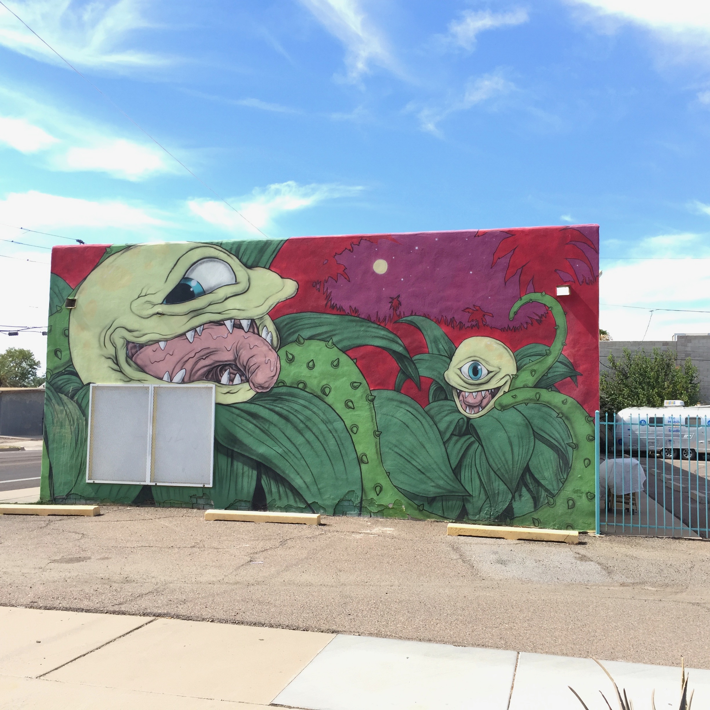 These creepy carnivorous plants go right around the corner and down the other side of this building.